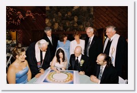 28_2614-217-31A * Jessica signs the Ketubah while parents, rabbi and minister, and witnesses look on * 2384 x 1527 * (897KB)